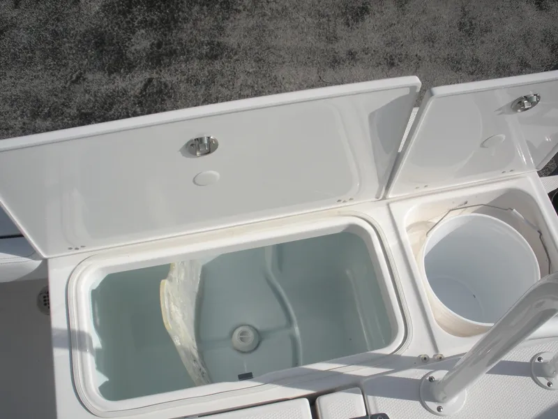 Slide: The Image of Open storage compartments on a 2026 Robalo R246 Caymann boat deck. - 15