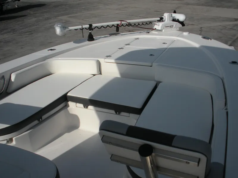 Slide: The Image of 2026 Robalo R246 Caymann boat interior with cushioned seating and trolling motor. - 3