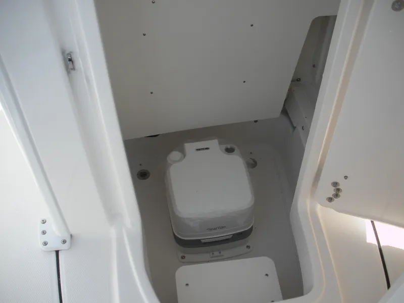 Slide: The Image of 2026 Robalo R246 Caymann boat interior with compact marine toilet. - 5