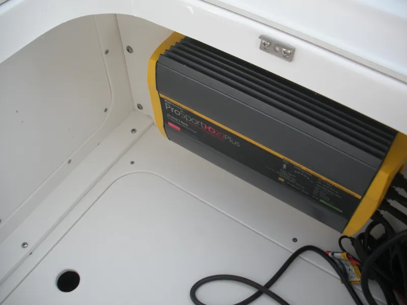 Slide: The Image of 2026 Robalo R246 Caymann boat compartment with ProSport HD20Plus battery charger. - 6