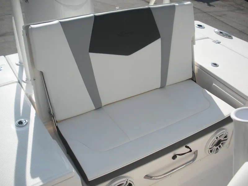 Slide: The Image of 2026 Robalo R246 Caymann boat seat with white and gray upholstery. - 14