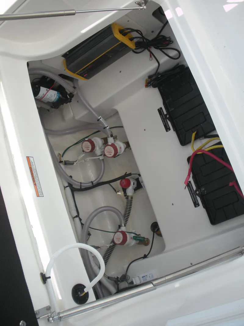 Slide: The Image of 2026 Robalo R246 Caymann boat interior showing battery compartment and wiring. - 18