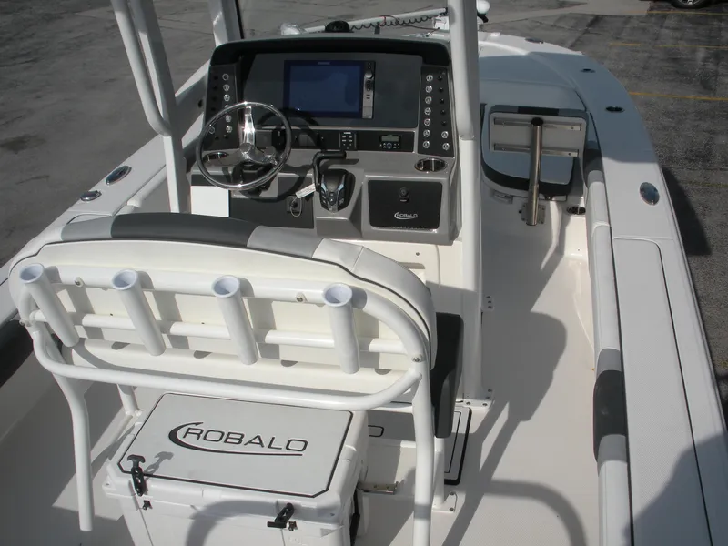 Slide: The Image of 2026 Robalo R246 Caymann boat interior with steering console and seating. - 9