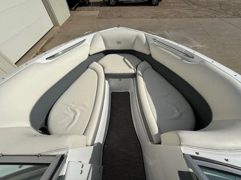Slide: The Image of 2015 Cobalt 220 boat interior with white cushioned seating and gray accents. - 10