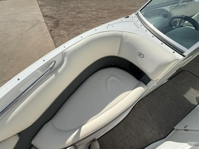 Slide: The Image of 2015 Cobalt 220 boat interior with white seating and steering wheel. - 11