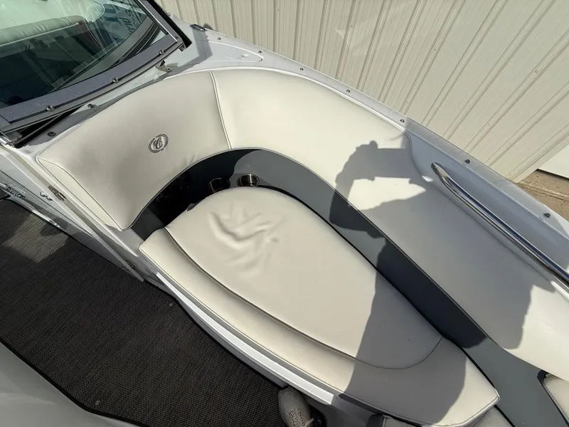 Slide: The Image of 2015 Cobalt 220 boat interior with white seating and cup holders. - 12