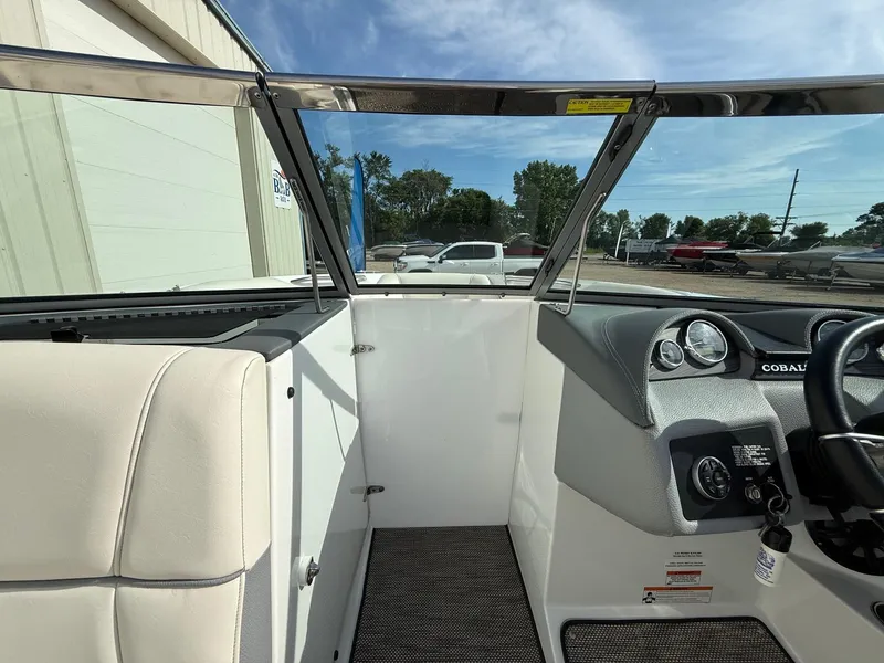 Slide: The Image of Interior view of a 2015 Cobalt 220 boat cockpit with steering wheel and dashboard. - 13
