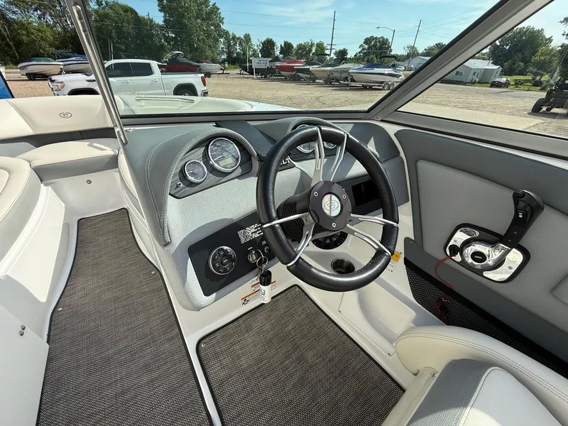 Slide: The Image of 2015 Cobalt 220 boat interior with steering wheel and dashboard controls. - 14