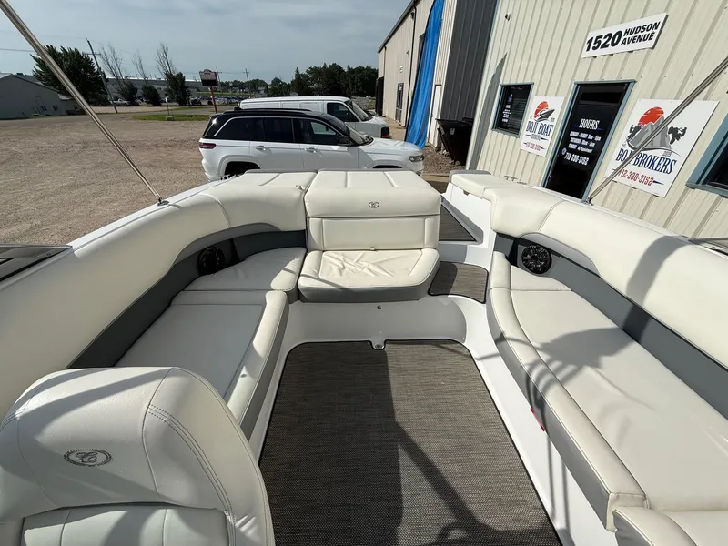 Slide: The Image of Interior of a 2015 Cobalt 220 boat with white seating and carpeted floor. - 16