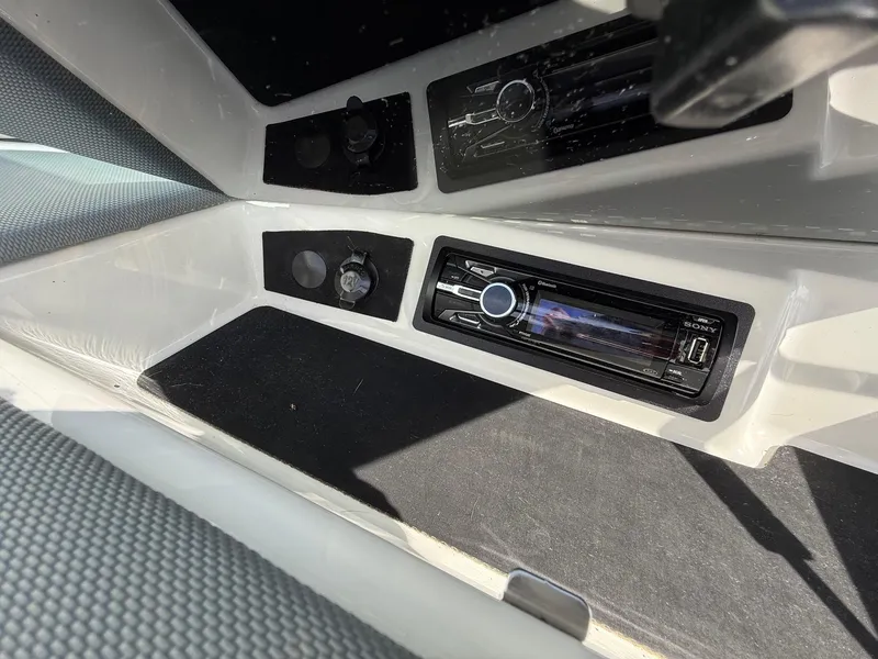 Slide: The Image of Boat interior with Sony stereo system in a 2015 Cobalt 220. - 18