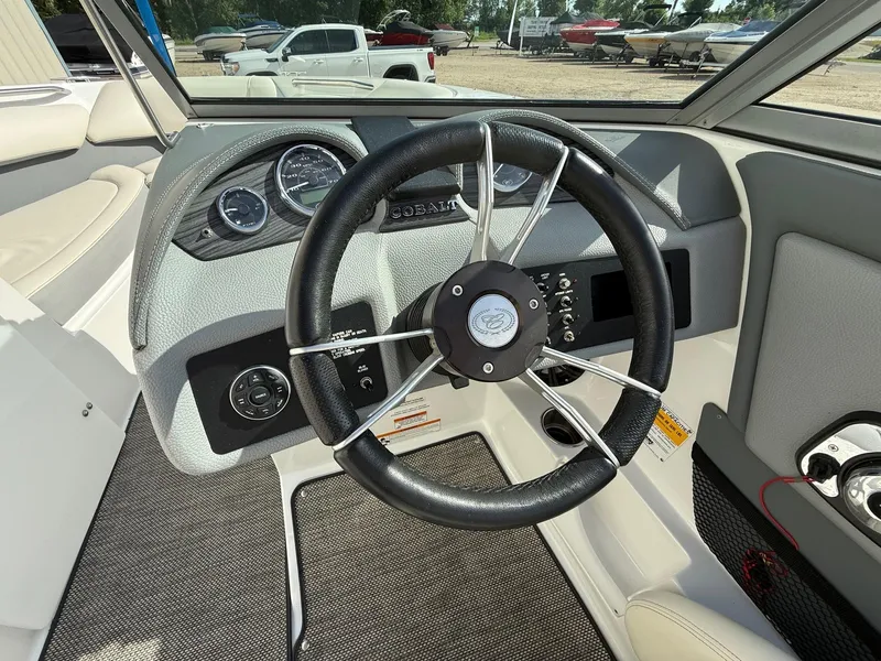 Slide: The Image of Steering wheel and dashboard of a 2015 Cobalt 220 boat. - 21
