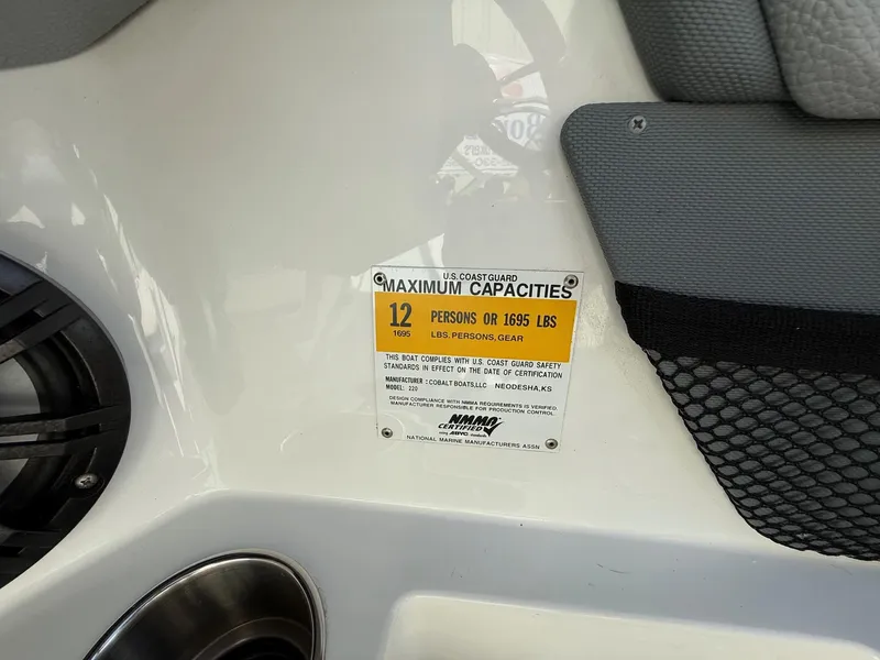 Slide: The Image of Cobalt 220 boat capacity label, 12 persons or 1695 lbs, 2015 model. - 23