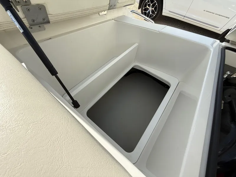 Slide: The Image of Open storage compartment in a 2015 Cobalt 220 boat, showcasing interior space. - 25