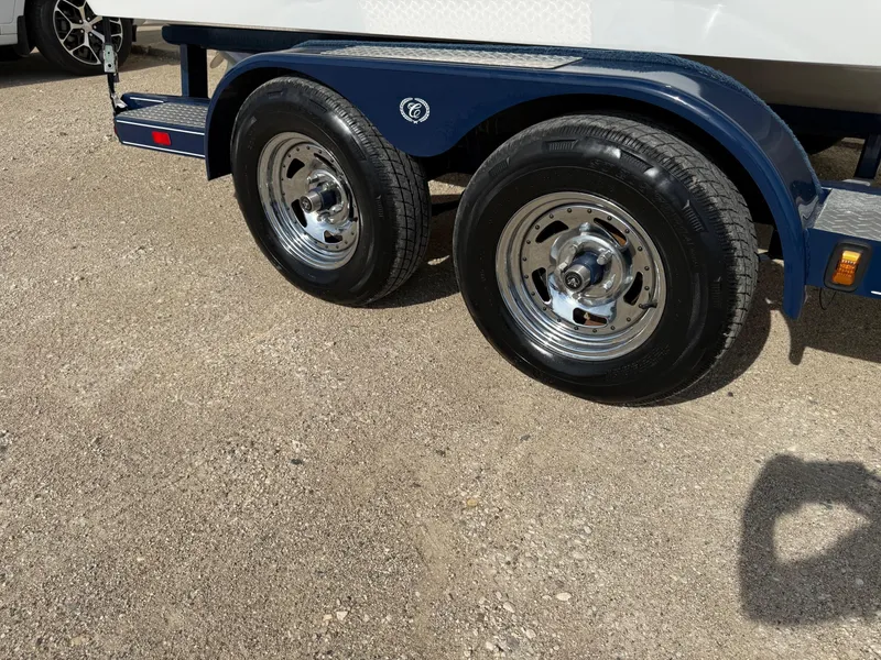 Slide: The Image of Trailer wheels of a 2015 Cobalt 220 boat on gravel surface. - 28