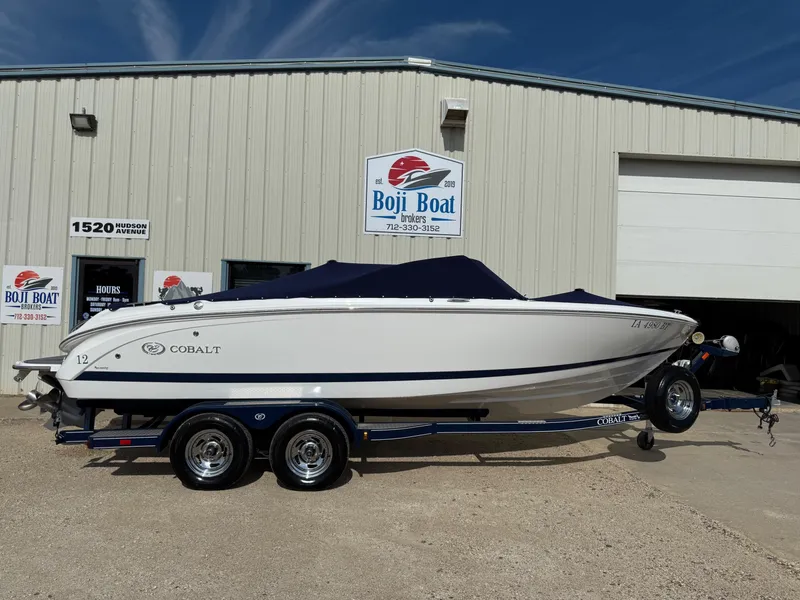 Slide: The Image of 2015 Cobalt 220 boat on trailer outside Boji Boat Brokers building. - 32