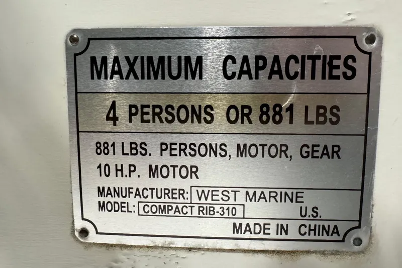 Slide: The Image of West Marine Compact Rib-310 capacity plate, 4 persons, 881 lbs, 10 HP. - 12