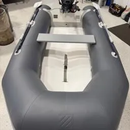 Slide: The Image of 2022 West Marine Compact Rib-310 inflatable boat in a garage setting. - 5