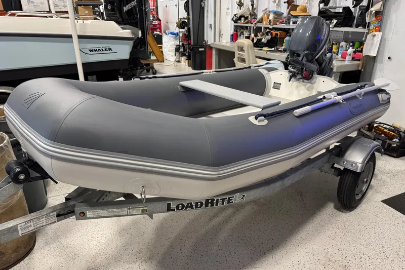 The Image of West Marine Compact Rib-310 inflatable boat on trailer, year 2022. - 8