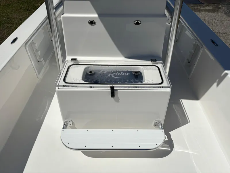Slide: The Image of 2025 Bay Rider 2260 Skiff interior with storage compartment and step. - 11