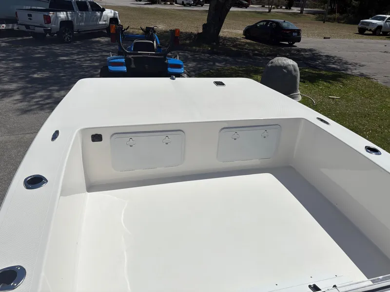 Slide: The Image of 2025 Bay Rider 2260 Skiff boat interior, featuring spacious deck and storage compartments. - 12
