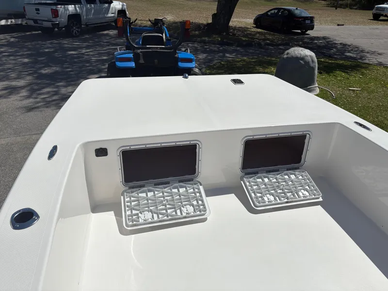 Slide: The Image of 2025 Bay Rider 2260 Skiff boat deck with open storage compartments. - 13