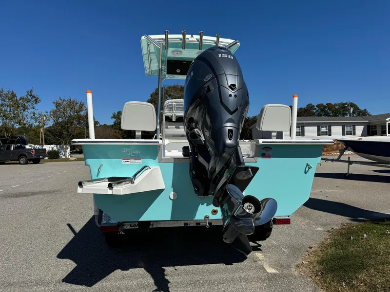 Slide: The Image of 2025 Bay Rider 2260 Skiff with outboard motor, parked on a sunny day. - 5
