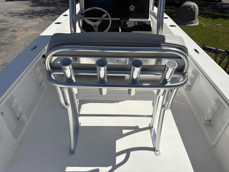 Slide: The Image of Bay Rider 2260 Skiff 2025 boat interior with rod holders and steering wheel. - 7