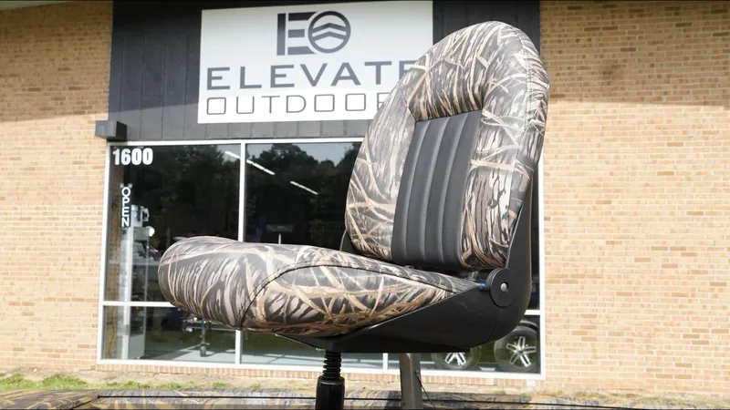 Slide: The Image of Camouflage boat seat in front of Elevated Outdoor store, G3 Bay 17, 2025 model. - 12