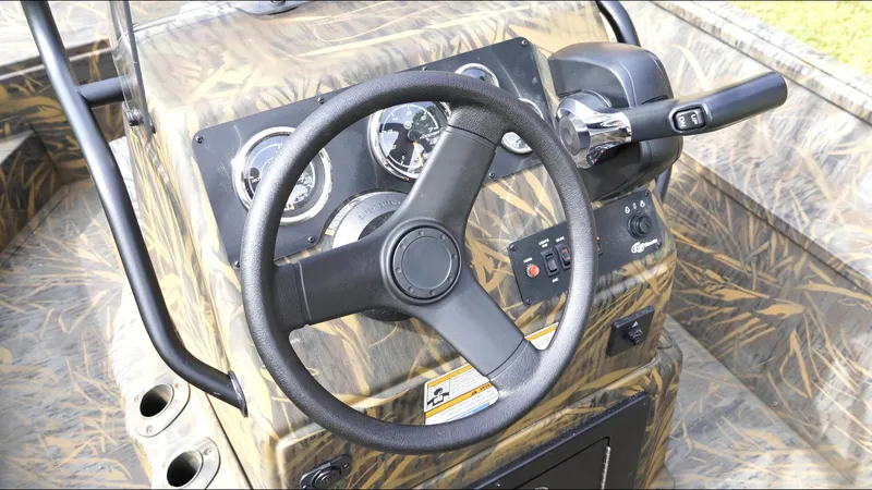 Slide: The Image of Steering console of 2025 G3 Bay 17 boat with camouflage design and control panel. - 15