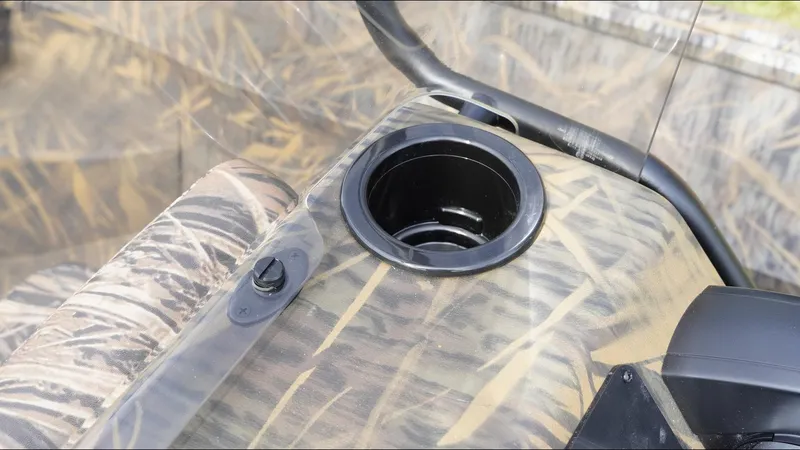 Slide: The Image of Camouflage interior of 2025 G3 Bay 17 boat with cup holder and control knob. - 16