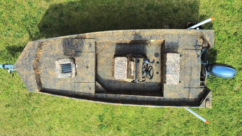 Slide: The Image of Top view of 2025 G3 Bay 17 boat with camouflage design on grass. - 2