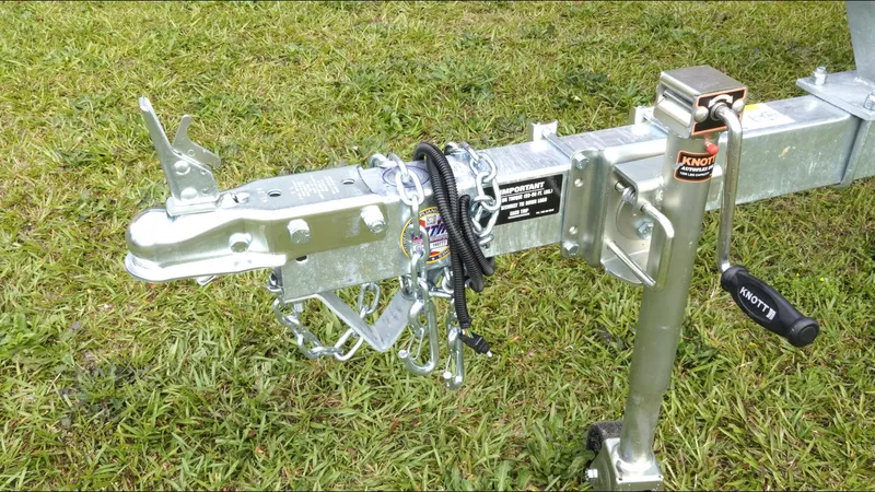 Slide: The Image of Trailer hitch and jack on grass, G3 Bay 17 model, 2025. - 25