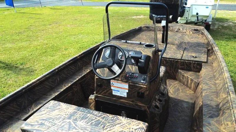 Slide: The Image of 2025 G3 Bay 17 boat interior with camouflage design, featuring steering console and seating. - 3