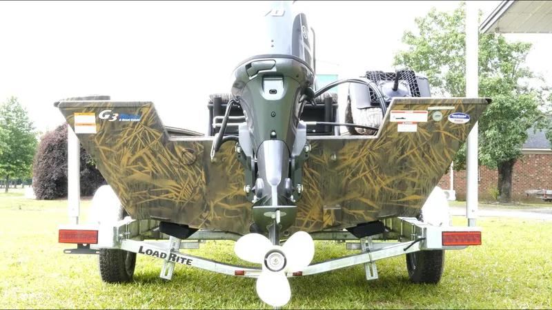 Slide: The Image of 2025 G3 Bay 17 boat on Load Rite trailer, rear view, camo design. - 7