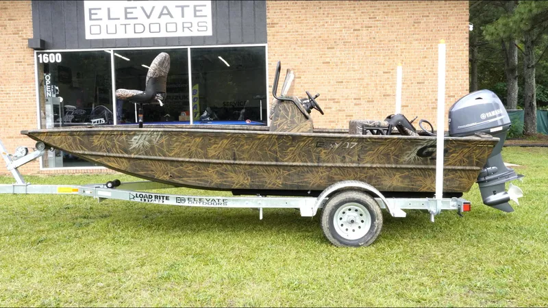 Slide: The Image of 2025 G3 Bay 17 boat on trailer outside Elevate Outdoors store. - 8