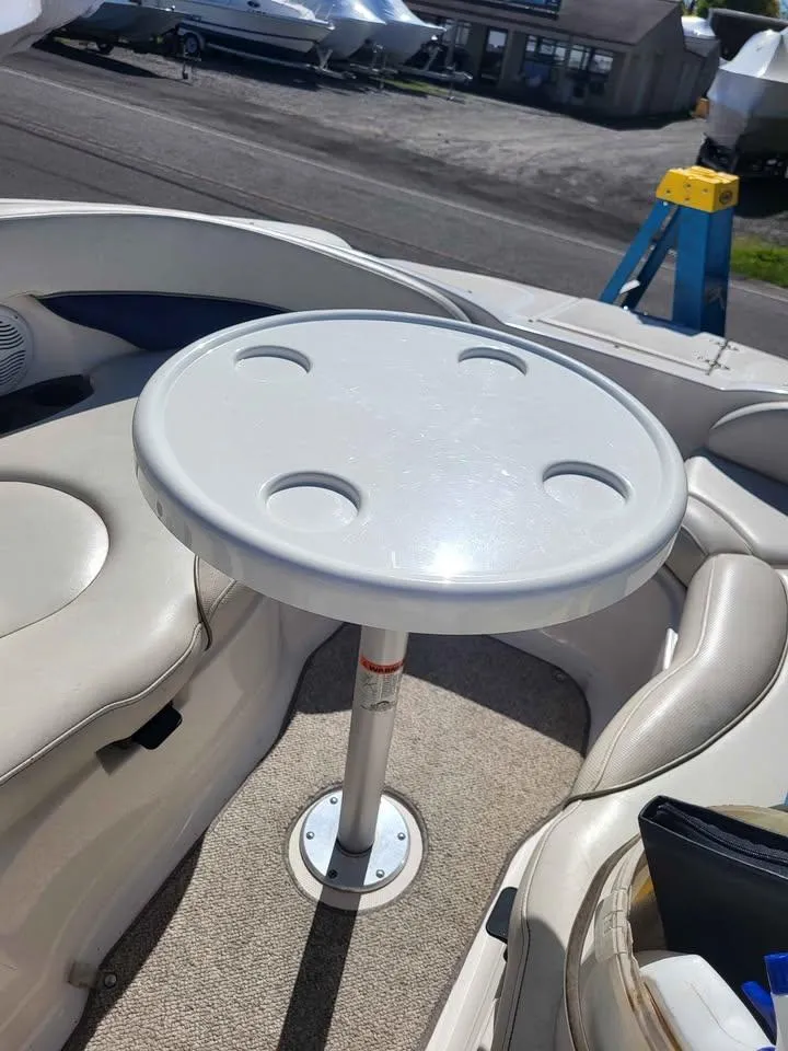 Slide: The Image of 2005 Monterey 263 ES Explorer boat interior with round table and seating. - 13