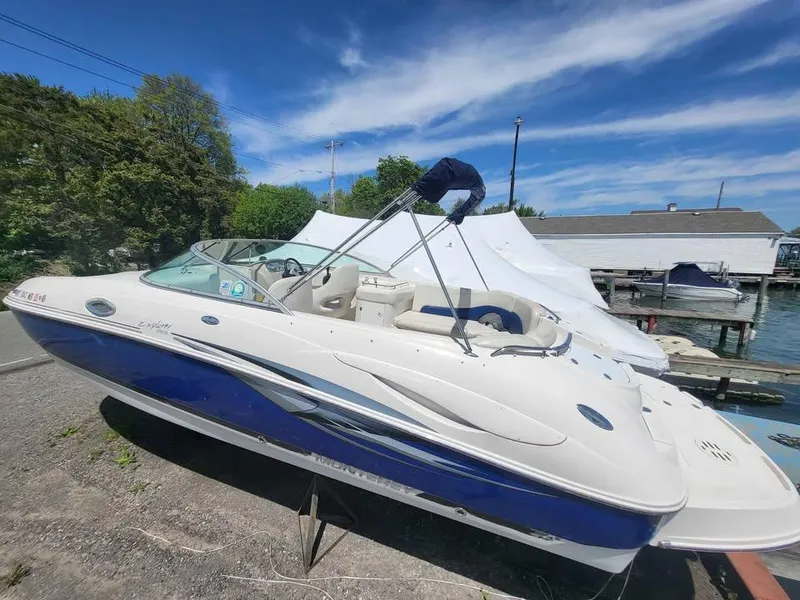 Slide: The Image of 2005 Monterey 263 ES Explorer boat docked under clear blue sky. - 14