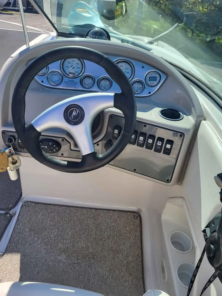 Slide: The Image of Steering console of a 2005 Monterey 263 ES Explorer boat with gauges and controls. - 15