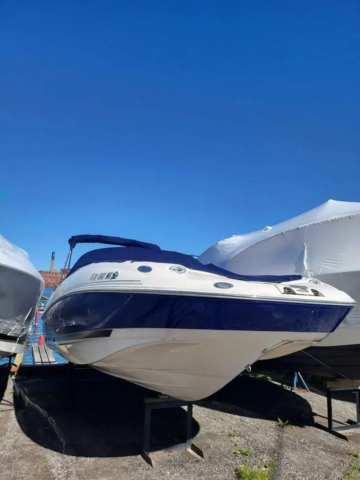Slide: The Image of 2005 Monterey 263 ES Explorer boat on display under clear blue sky. - 3
