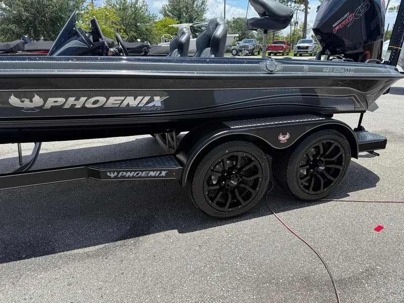 Slide: The Image of 2026 Phoenix 920 ELITE X II boat on trailer, black finish, parked outdoors. - 5