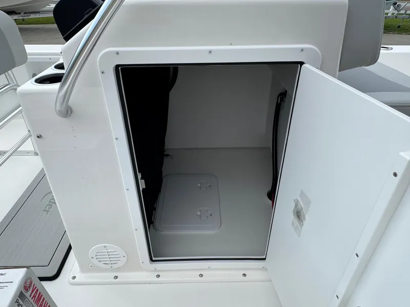 Slide: The Image of Open storage compartment on 2025 Bay Rider 2060 Skiff boat, showcasing interior space. - 14