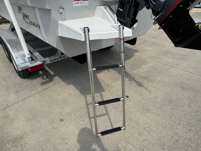 Slide: The Image of Bay Rider 2060 Skiff 2025 with a stainless steel boarding ladder on a trailer. - 5
