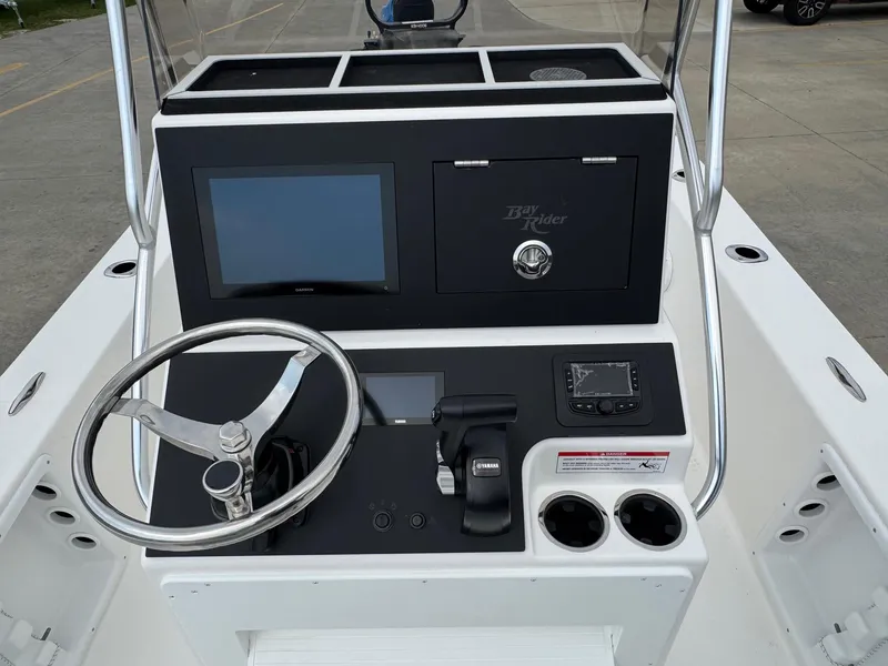 Slide: The Image of 2025 Bay Rider 2060 Skiff console with steering wheel, controls, and display screens. - 16