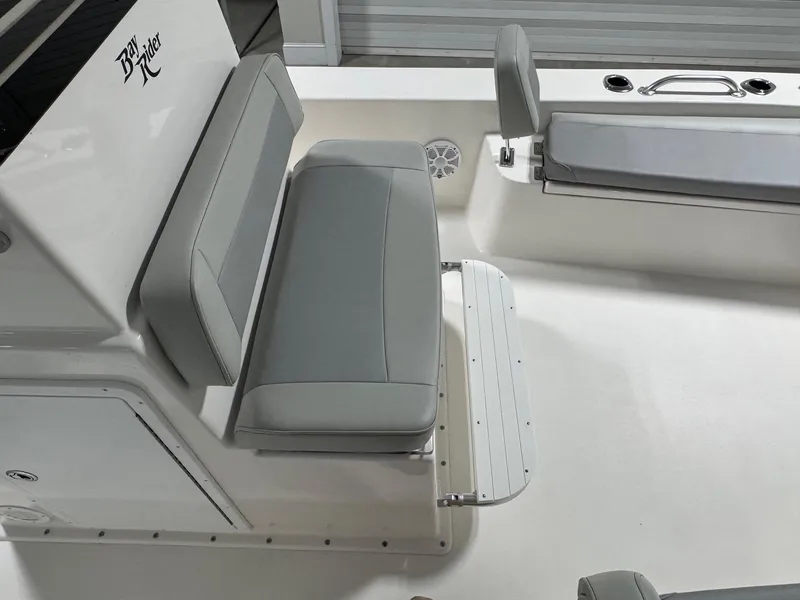 Slide: The Image of 2026 Bay Rider 2260 FS Skiff interior with gray seating and storage compartments. - 11