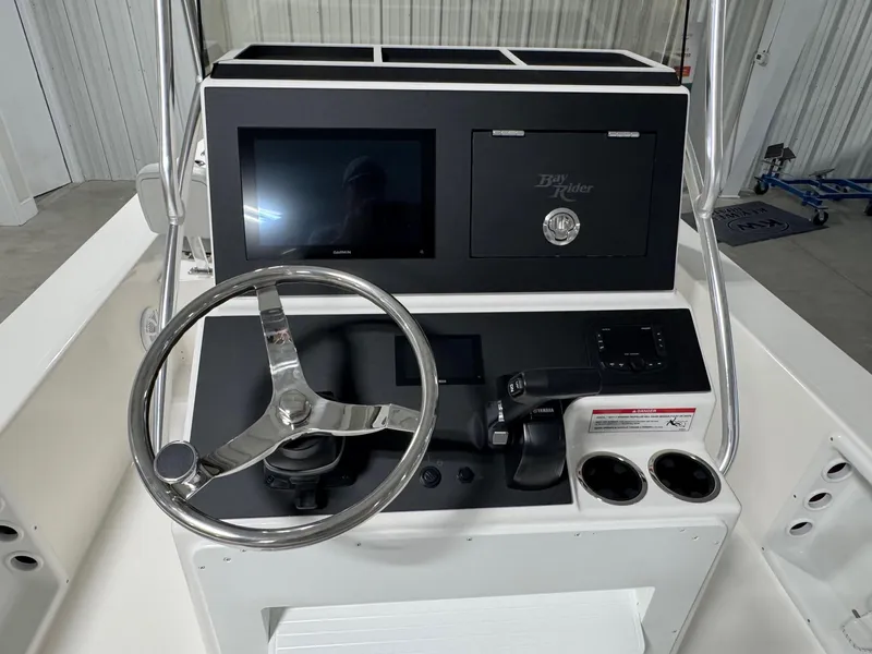 Slide: The Image of 2026 Bay Rider 2260 FS Skiff console with steering wheel, controls, and display screen. - 16
