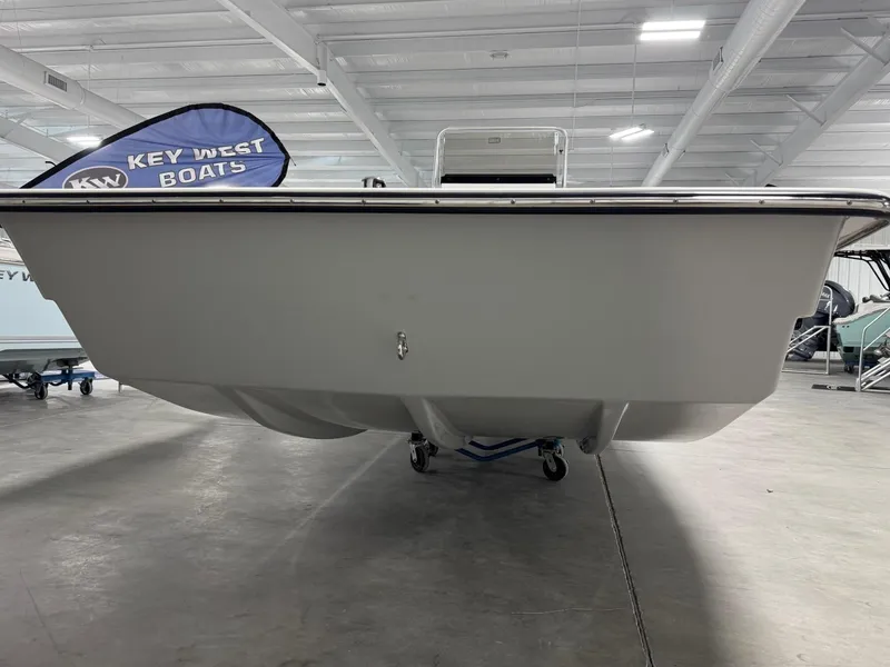 Slide: The Image of 2026 Bay Rider 2260 FS Skiff in showroom, front view, with Key West Boats banner. - 2