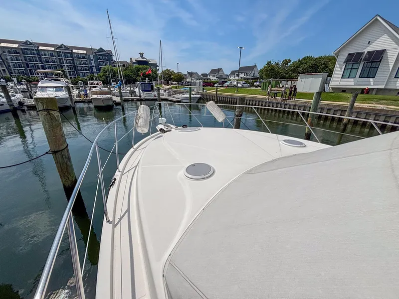 Slide: The Image of 2007 Silverton 38 Convertible yacht docked at a marina under a clear blue sky. - 11