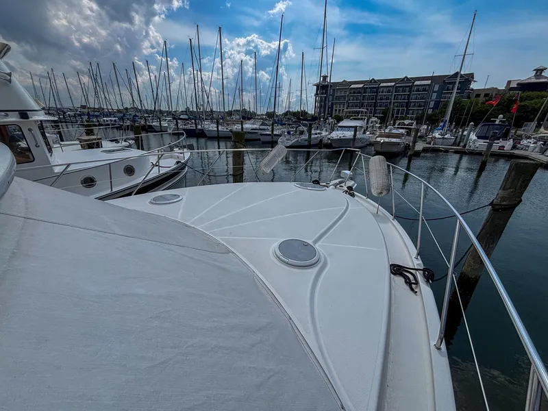 Slide: The Image of 2007 Silverton 38 Convertible yacht docked in a marina under a partly cloudy sky. - 13