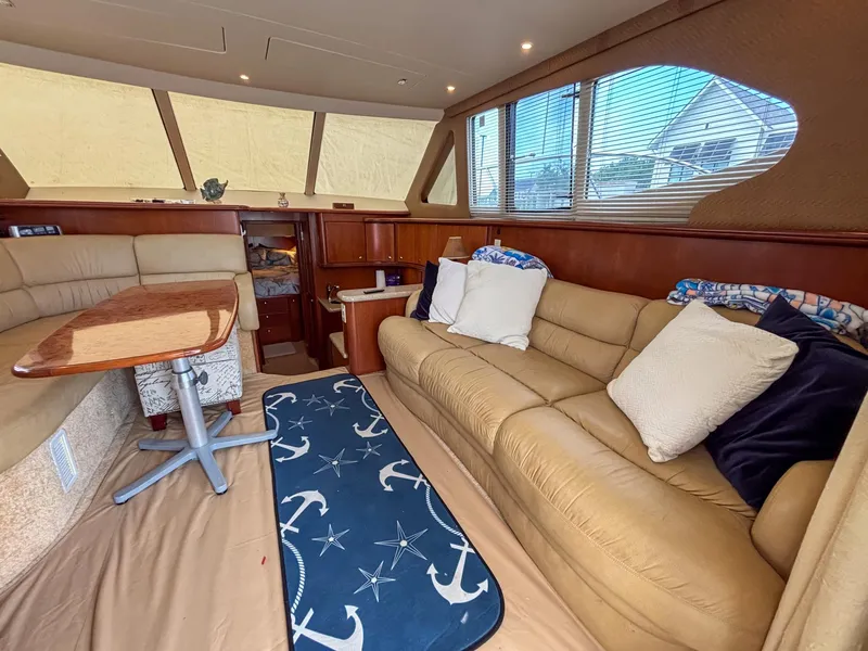 Slide: The Image of Luxurious interior of 2007 Silverton 38 Convertible yacht with plush seating and nautical decor. - 15