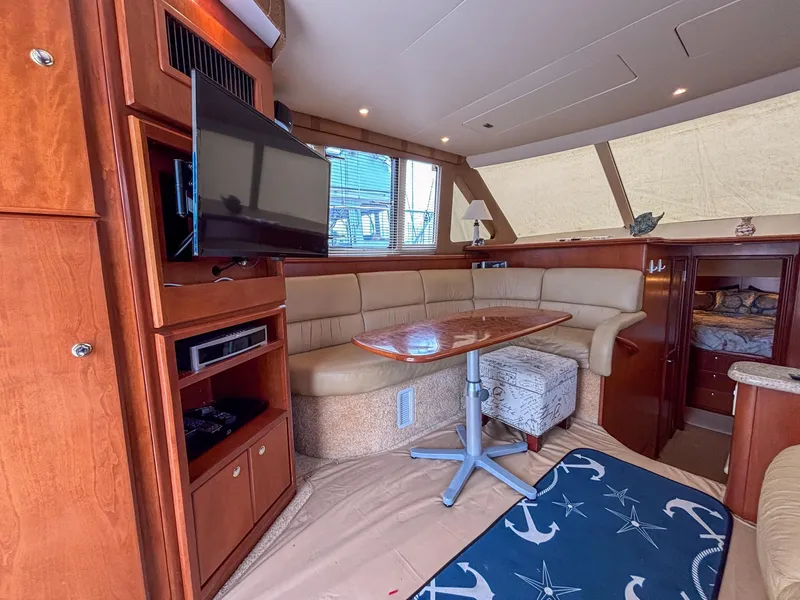 Slide: The Image of Luxurious interior of a 2007 Silverton 38 Convertible yacht with leather seating and entertainment system. - 17
